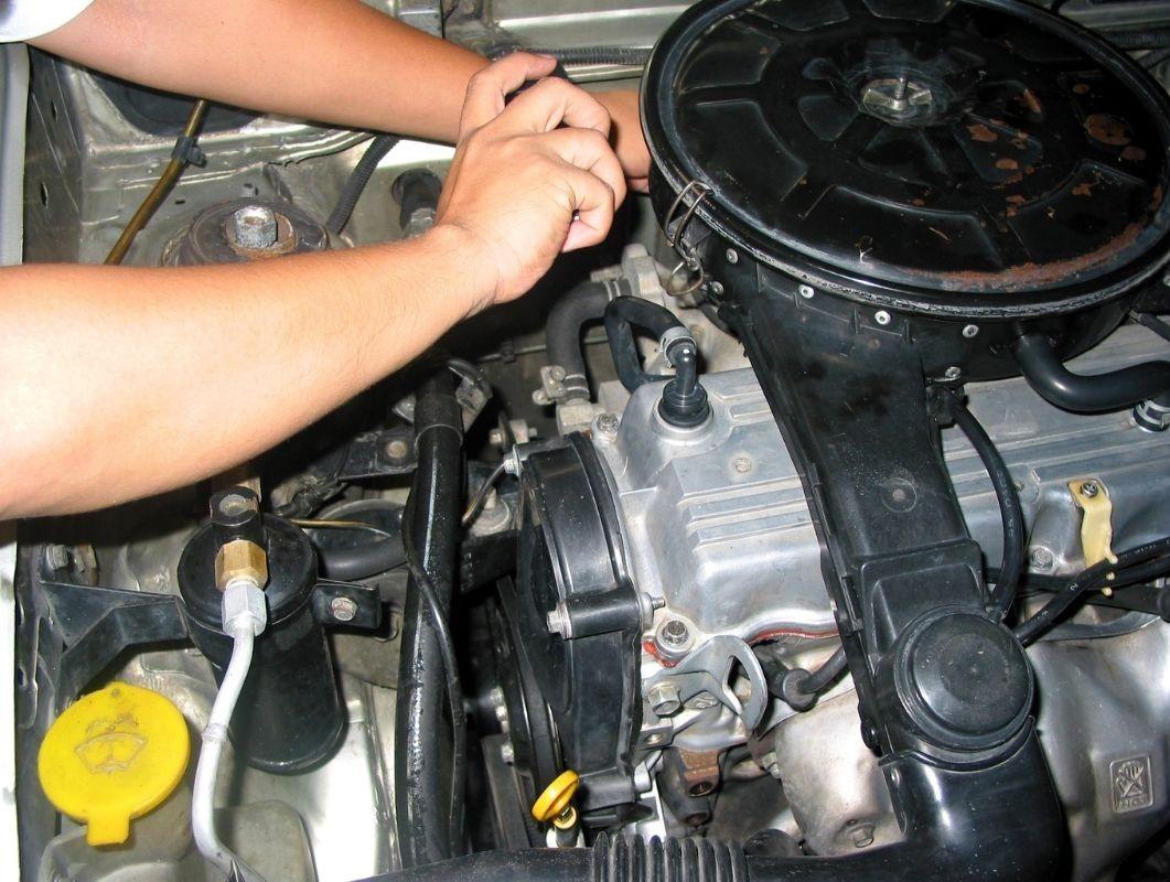 Mechanic checking engine.