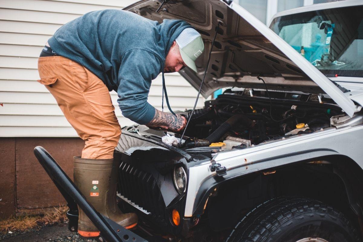 Mechanic checking the car engine. 