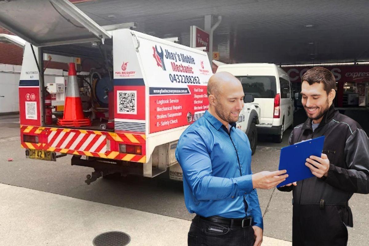 Two men discussing a vehicle issue at a service station. 